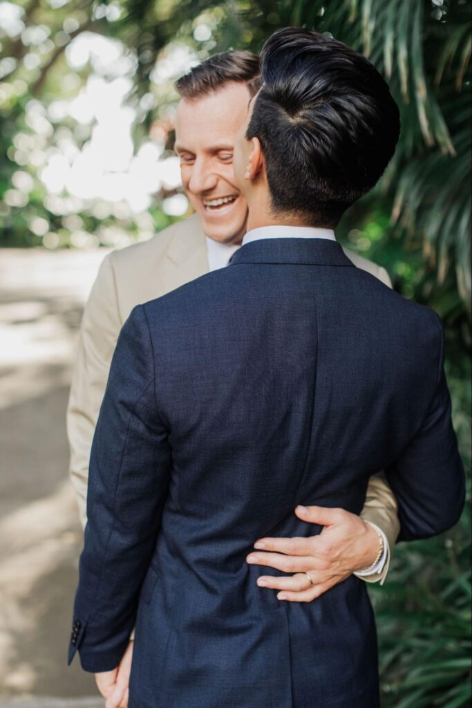 two grooms smiling and hugging