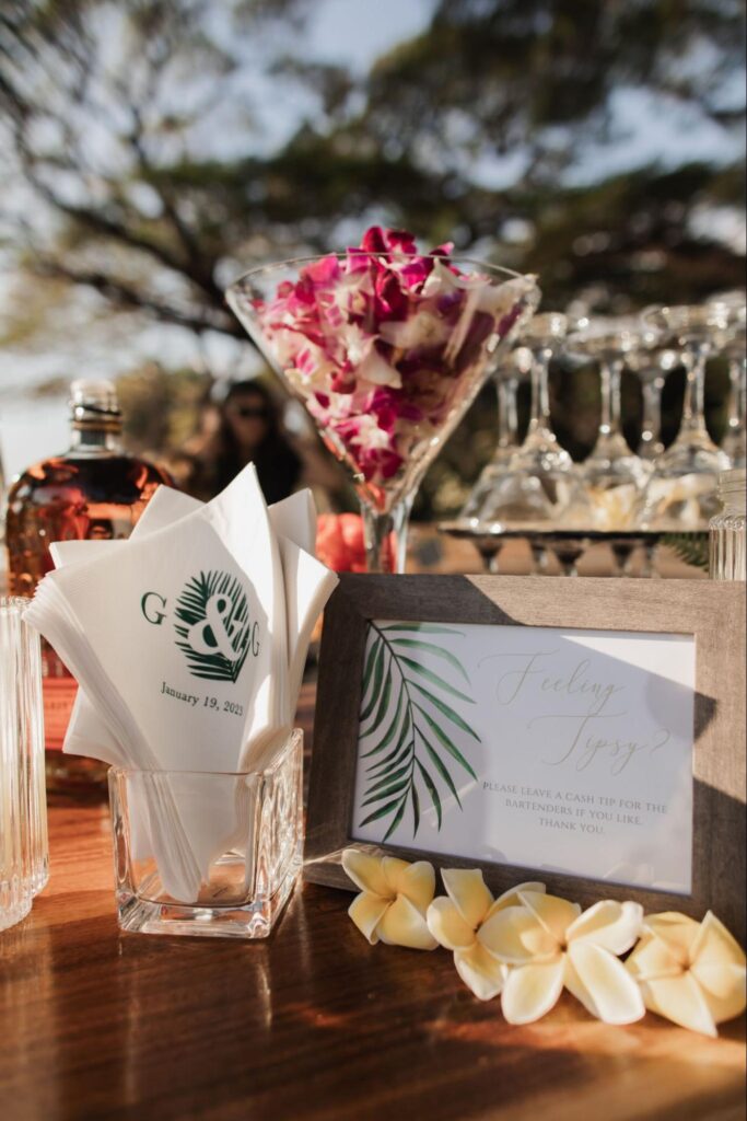 custom cocktail napkins and a bar sign at a Maui wedding