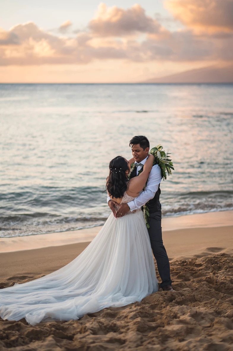 bride and groom on the beach in Maui at sunset