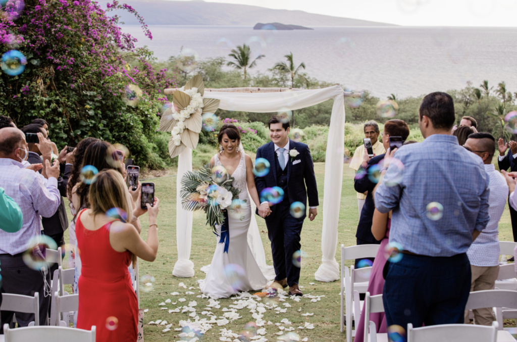 a couple walks down the aisle after saying "I Do" during their Wailea Maui wedding