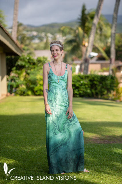 a smiling bride in a green gown posing out doors in Maui Hawaii