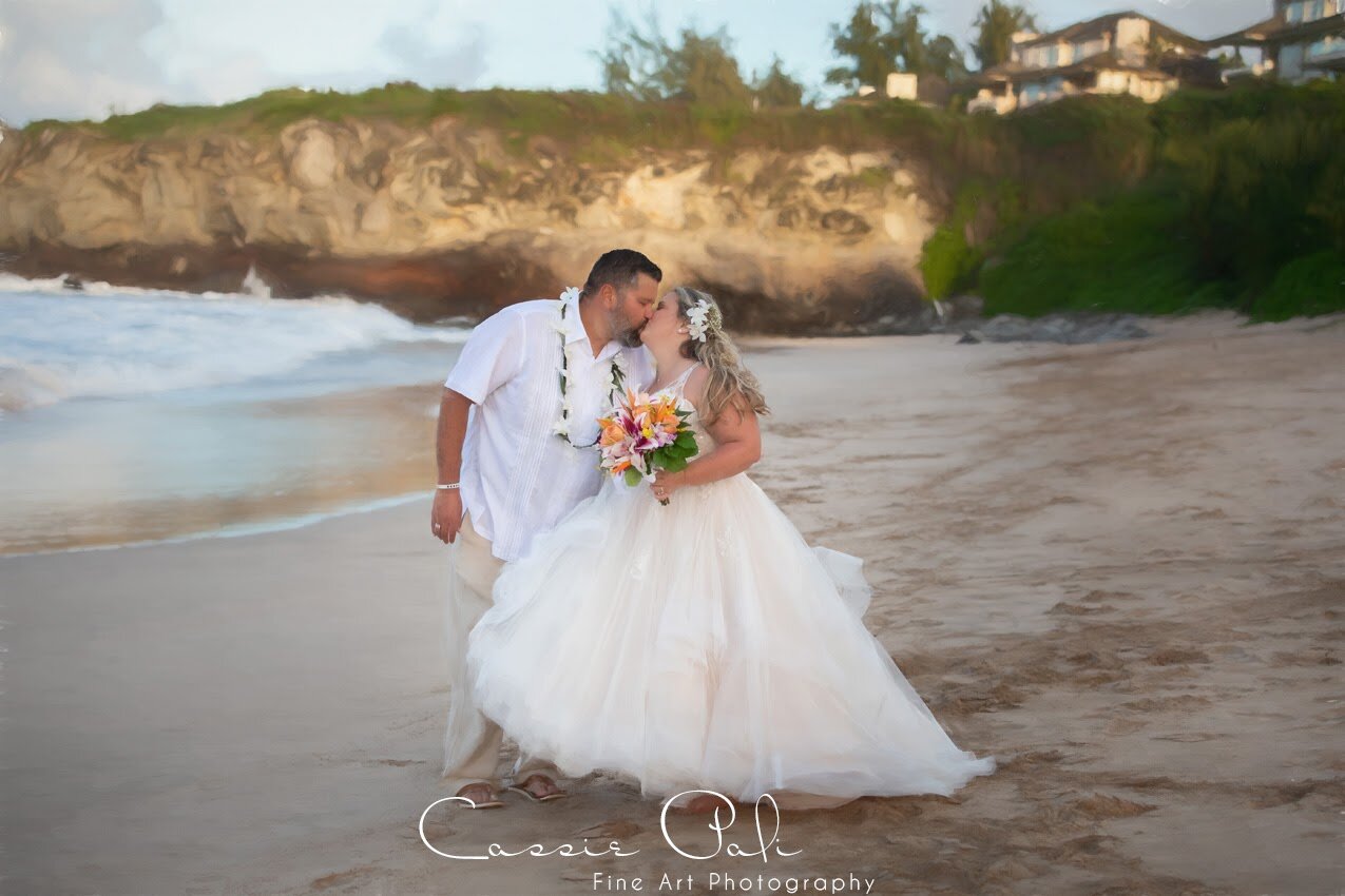 bride and groom kiss on Maui beach