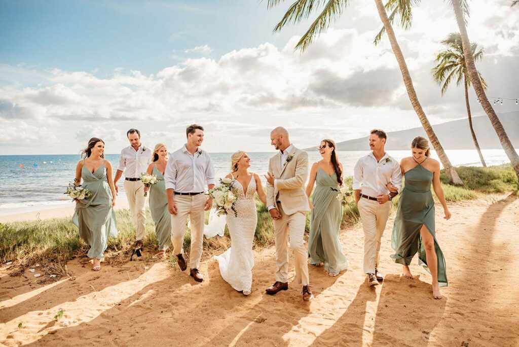 wedding party walking along sand at Sugar Beach Events wedding venue in Maui